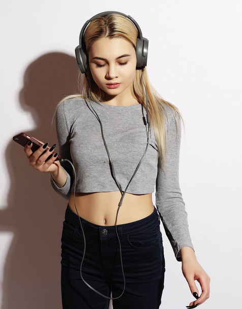 lifestyle and people concept: Beautiful young woman listening to music in headphones - Photo, image