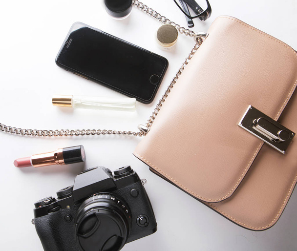 Top view of woman beige bag with accessories smartphone, cosmeti - Fotografie, Obrázek