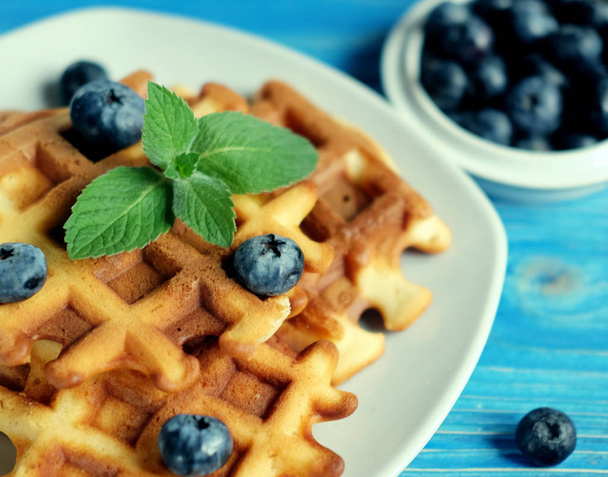 Homemade belgian waffles with fresh blueberry and raspberry over wooden background. Top view. - Foto, Imagen