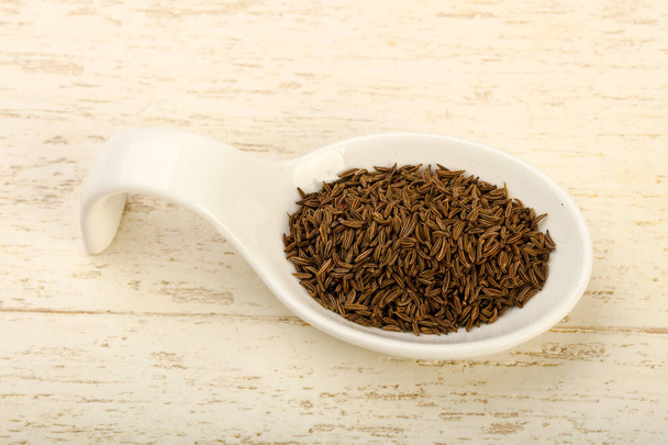 Caraway pile in the bowl over wooden background - Photo, Image