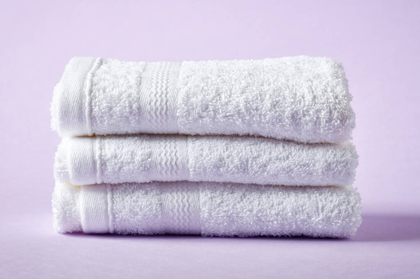White spa towels on purple background - 写真・画像