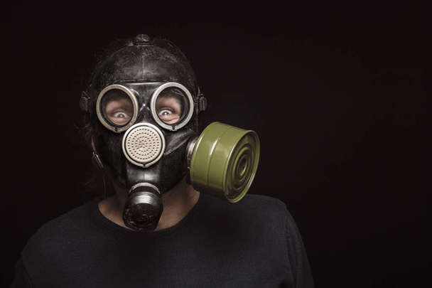 Portrait of man in gas mask with furious eyes, copy space - Photo, Image