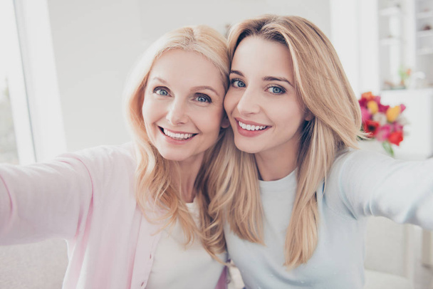 Self portrait of cute lovely similar trendy mother and daughter  - Foto, Imagen