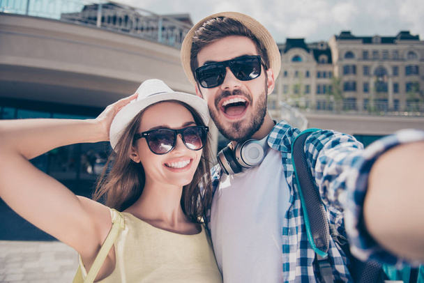 Positive trendy cheerful couple in caps having journey, trip, me - Φωτογραφία, εικόνα