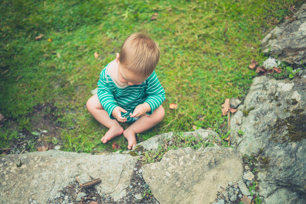 Little baby exploring nature by rocks - Foto, Bild