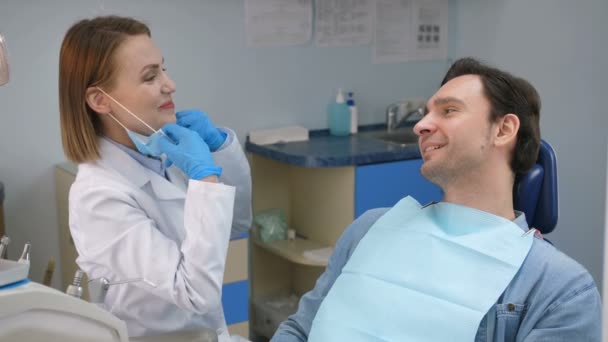 Dentist cheering patient before check-up in office - Footage, Video