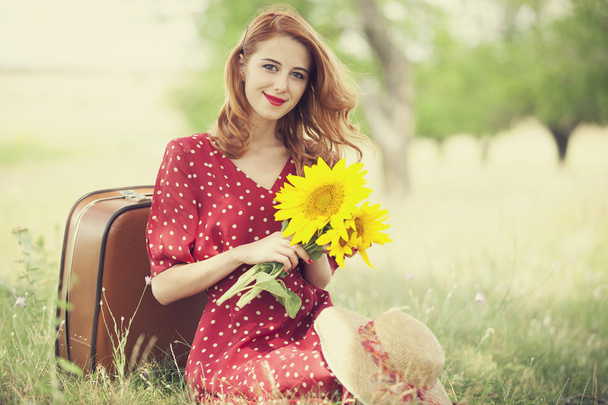 Redhead girl with sunflower at outdoor. - Φωτογραφία, εικόνα