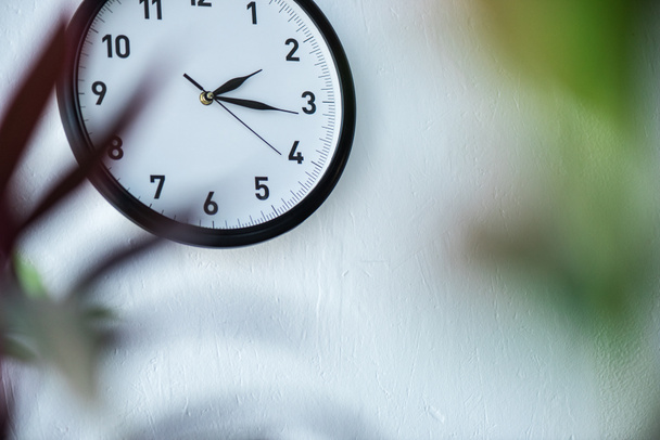 selective focus of black and white clock hanging on wall - Foto, Imagen