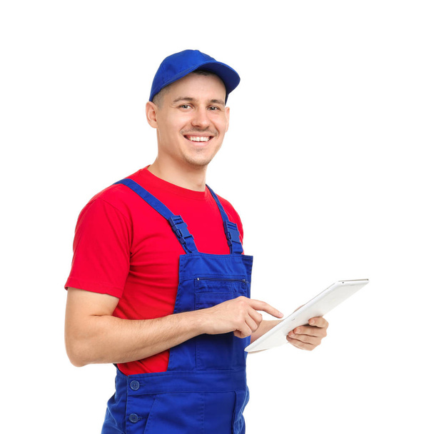 Young plumber with tablet computer on white background - Φωτογραφία, εικόνα