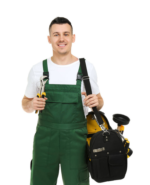 Young plumber with tool bag on white background - Fotoğraf, Görsel