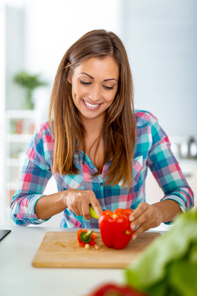 young woman making healthy meal in domestic kitchen - Photo, Image