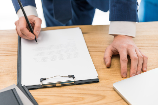 partial view of businessman signing papers at workplace  - Fotoğraf, Görsel
