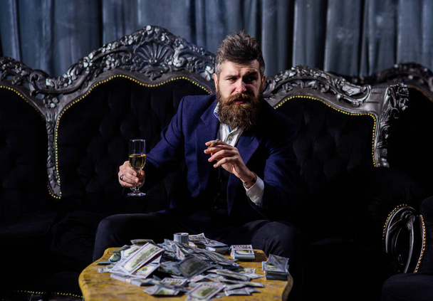 Millionaire in elegant suit smokes and drinks. - Φωτογραφία, εικόνα