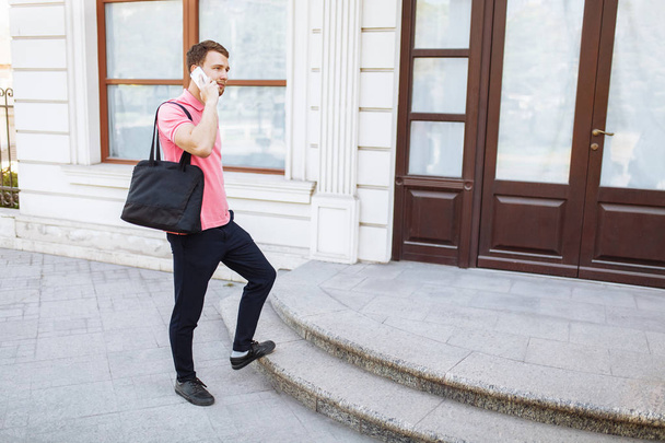 young handsome man walking around town and talking on the phone, hipster - Фото, зображення