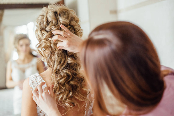 photo of young attractive bride with wedding hairstyle in light room preparing for wedding day - Fotografie, Obrázek
