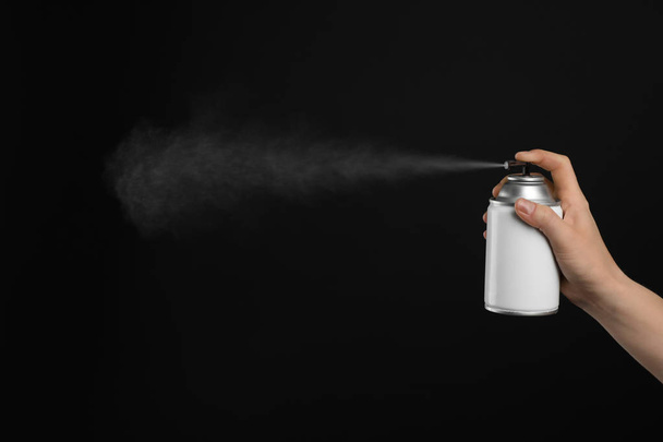 Woman spraying air freshener on black background, closeup - Fotoğraf, Görsel