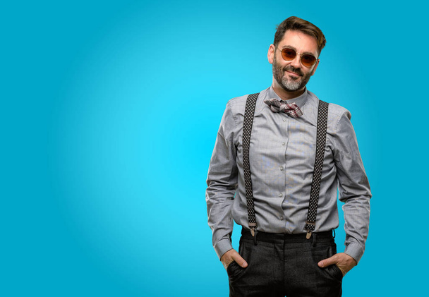 Middle age man, with beard and bow tie confident and happy with a big natural smile looking at camera - Photo, Image