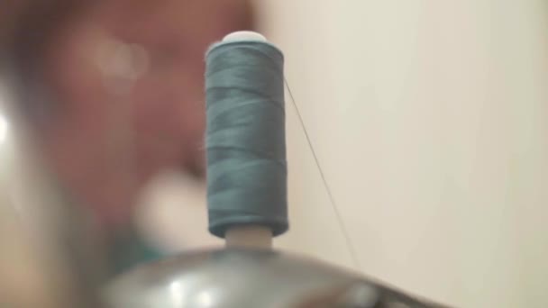 old woman sews jeans on old style seving machine - Footage, Video