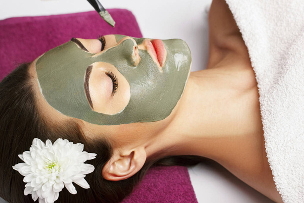 Woman with clay facial mask   in beauty spa. Skincare. Beauty Co - Valokuva, kuva
