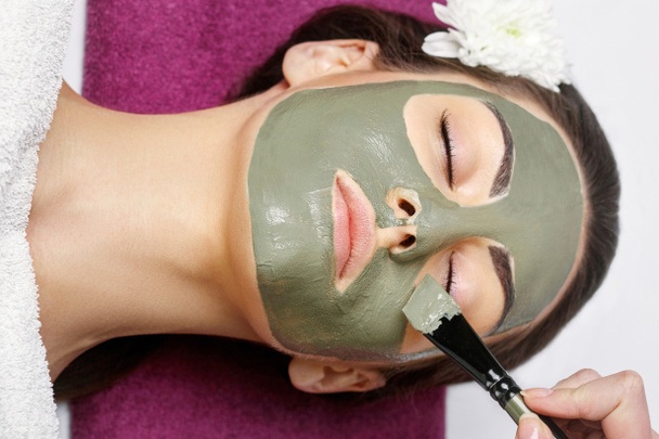 Spa Woman applying Facial clay Mask. Beauty Treatments. Close-up - Valokuva, kuva