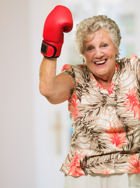 Happy Mature Woman Wearing Boxing Glove - Valokuva, kuva
