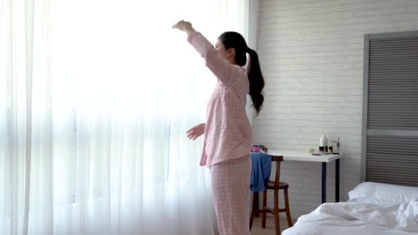 Asian woman doing a simple exercise in this pleasant morning. Stretching and opening her arms to warm up. - Video