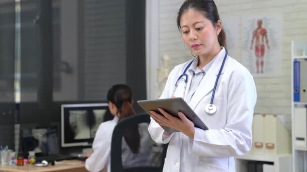 Beautiful young Asian Woman Doctor Thinking about Patient's Diagnosis. - Materiaali, video
