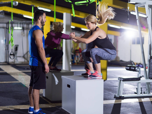 athletes working out  jumping on fit box - Foto, Imagen