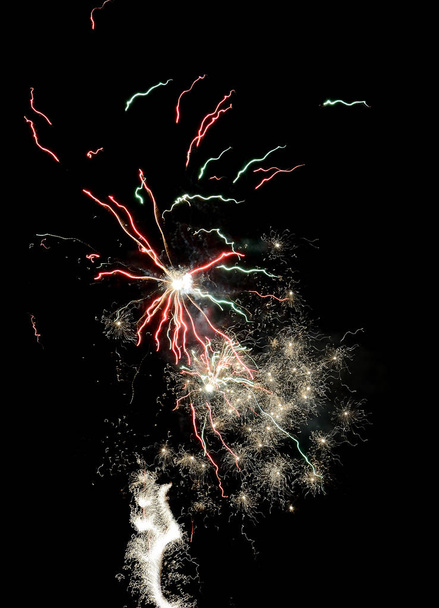 Gorgeous multi-colored fireworks display on dark background - Foto, afbeelding