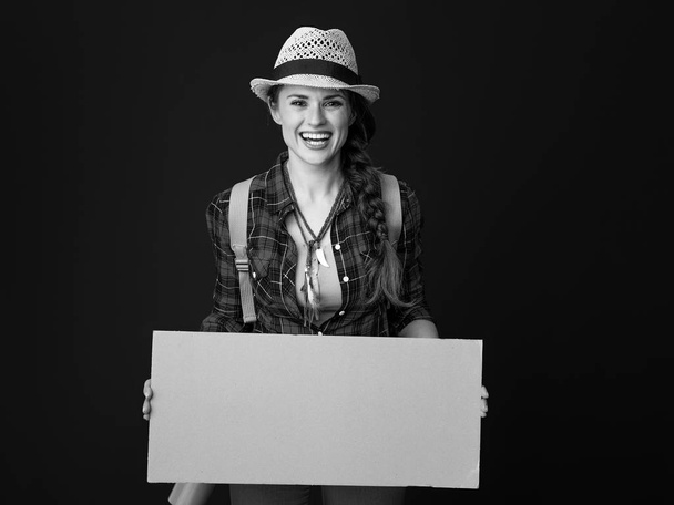 happy healthy woman hiker in a plaid shirt showing blank board - Zdjęcie, obraz