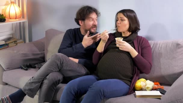 Husband telling pregnant wife she is eating too much - Materiał filmowy, wideo