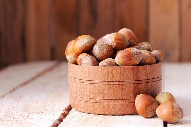 hazelnuts against the background of wood. useful snack. - Photo, Image