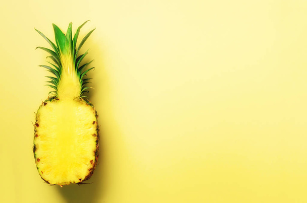 Half of sliced pineapple on yellow background. Top View. Copy Space. Bright pattern for minimal style. Pop art design, creative concept. - Photo, image