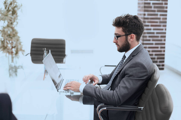 businessman working in bright office, sitting at desk - Фото, изображение