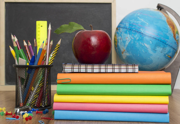 Globe, notebook stack and pencils. Schoolchild and student studies accessories. - Fotografie, Obrázek