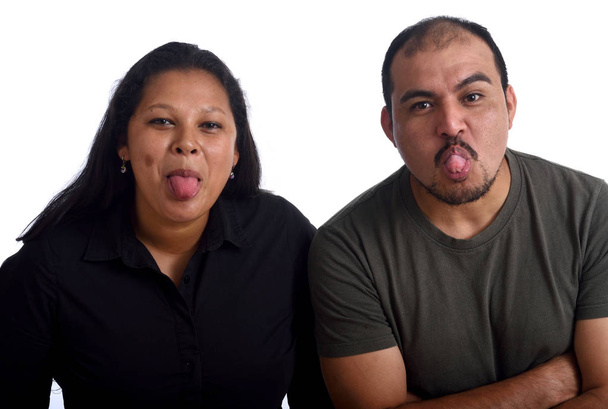 Couple sticking out tongue on white background - Photo, Image