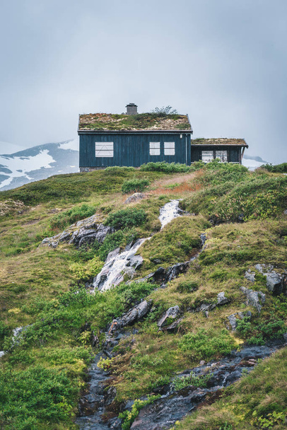 traditional wooden Norwegian cabins in foggy mountains - Photo, Image