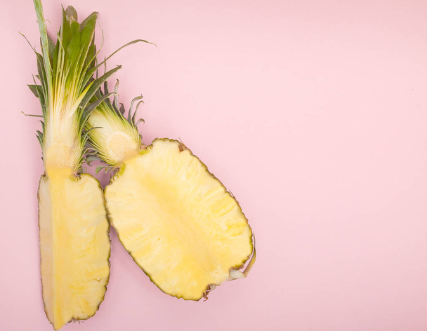 Half cut juicy pineapple on a pastel pink background. Minimal su - Photo, Image