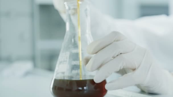 Handen onderzoeker infuus olie in reageerbuis in lab - Video