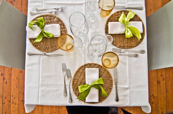 table set with plates and cutlery and glasses and a beautiful gr - Photo, Image
