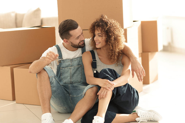 smiling couple on the background of large cardboard boxes. - Photo, Image