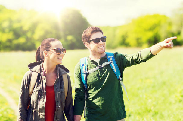 happy couple with backpacks hiking outdoors - Foto, imagen