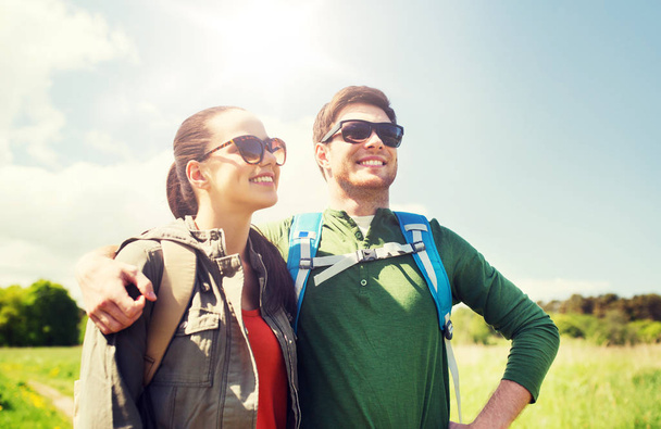 happy couple with backpacks hiking outdoors - Photo, image