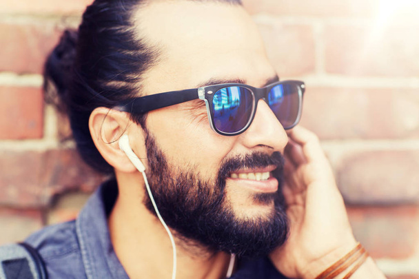 happy man with earphones listening to music - Фото, изображение