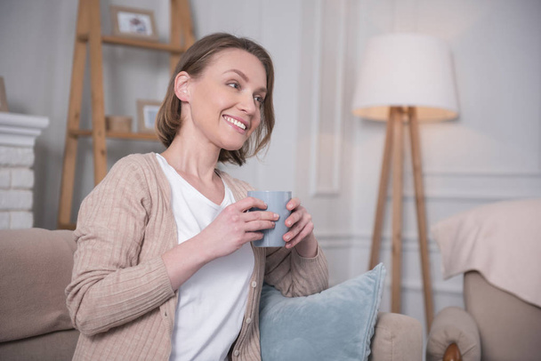 Happy woman drinking tea at home - Foto, Imagen