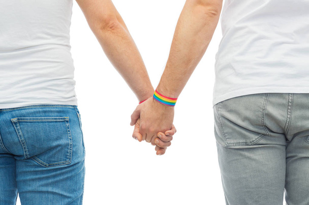 male couple with gay pride rainbow wristbands - Fotó, kép