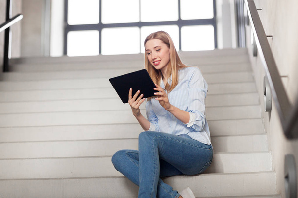 woman or student with tablet pc sitting on stairs - Photo, Image