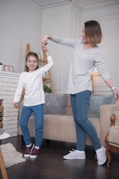 Exuberant girl dancing with her mom - Zdjęcie, obraz