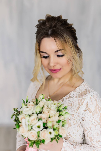 Beautiful woman in wedding dress in photo studio. - Фото, зображення