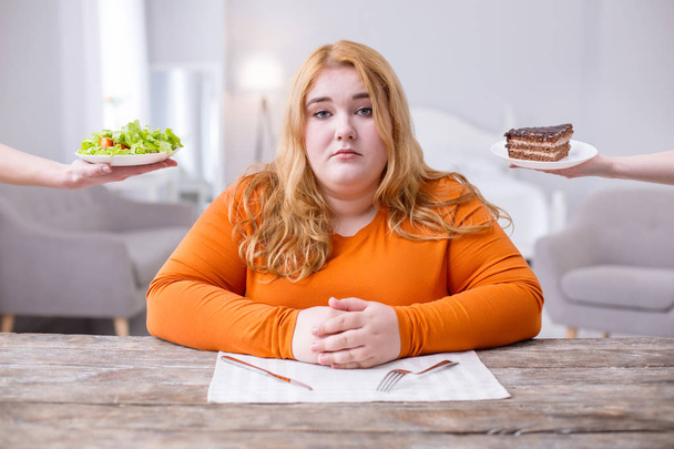 Poor overweight woman being on a diet - Foto, Imagen